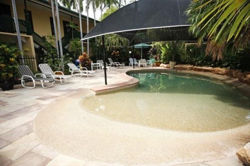 Shaded lagoon pool with tropical gardens - City Gardens Apartments