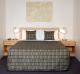 Comfortable Queen size bed facing the ground level view of the park and harbour
 - Harbour View Motel