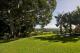 lawn area next to pool
 - Byron Hinterland Villas