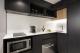 DELUXE APARTMENT KITCHEN
 - Tradewinds Hotel