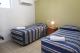Triple Share Room Bedroom
 - Tropic Coast Motel